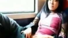 Asian milf rubs her clit on a train.